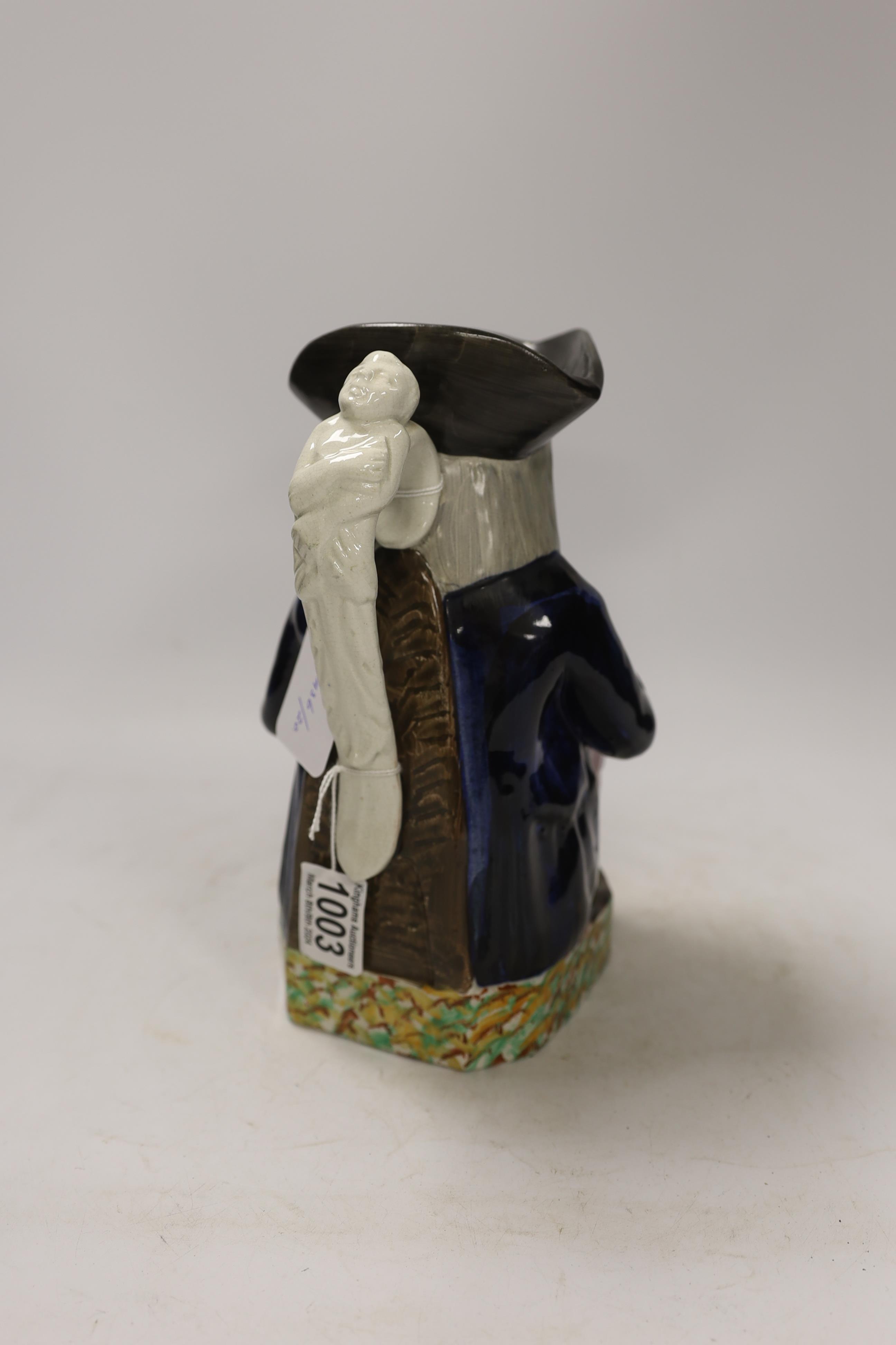 A Mexborough Toby jug, modelled holding a jug and a beaker, caryatid figural handle, black hat and sponge decorated base, 25cm high. Condition - fair